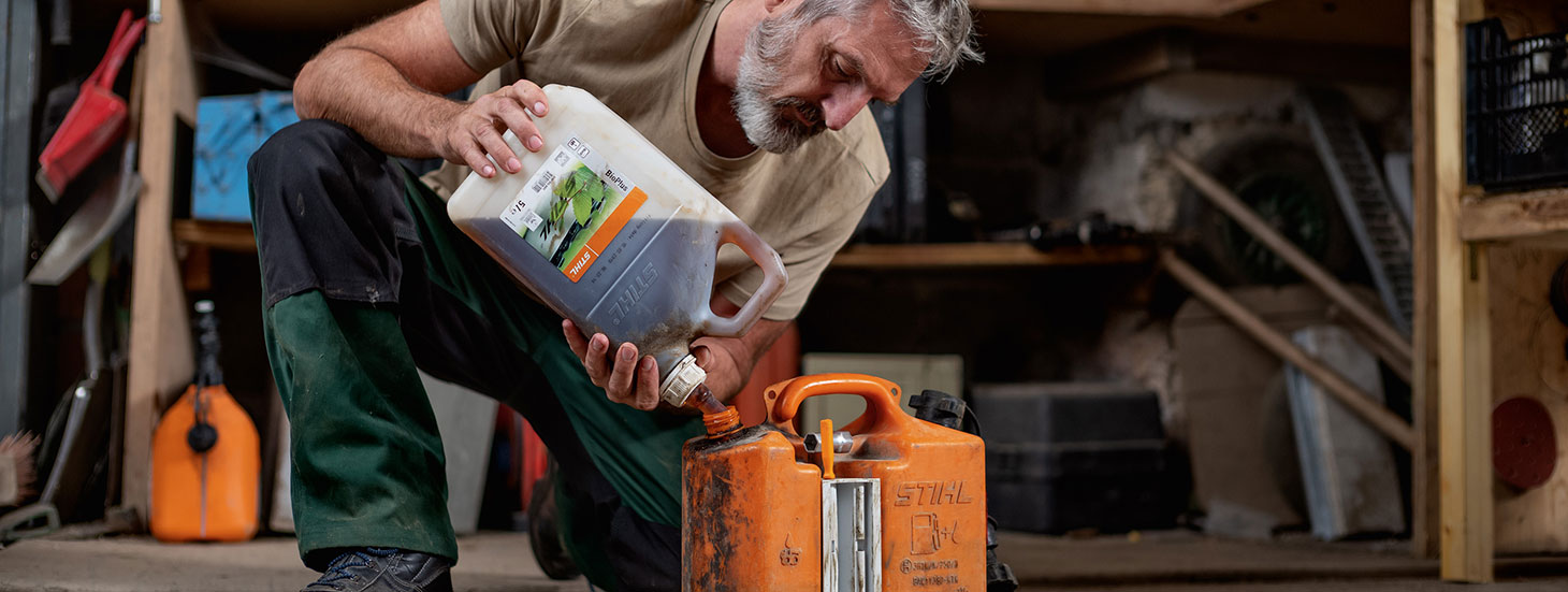 Man filling a STIHL combi can with fuel