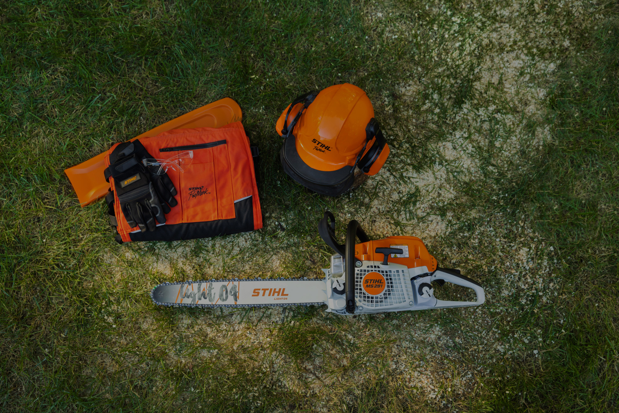 helmet and chainsaw trousers on grass