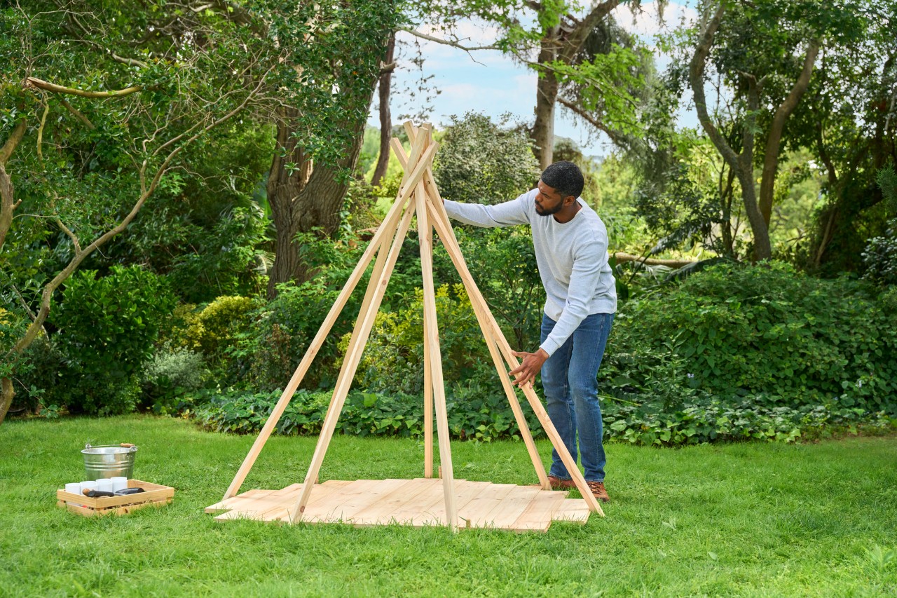 Man positions tent poles