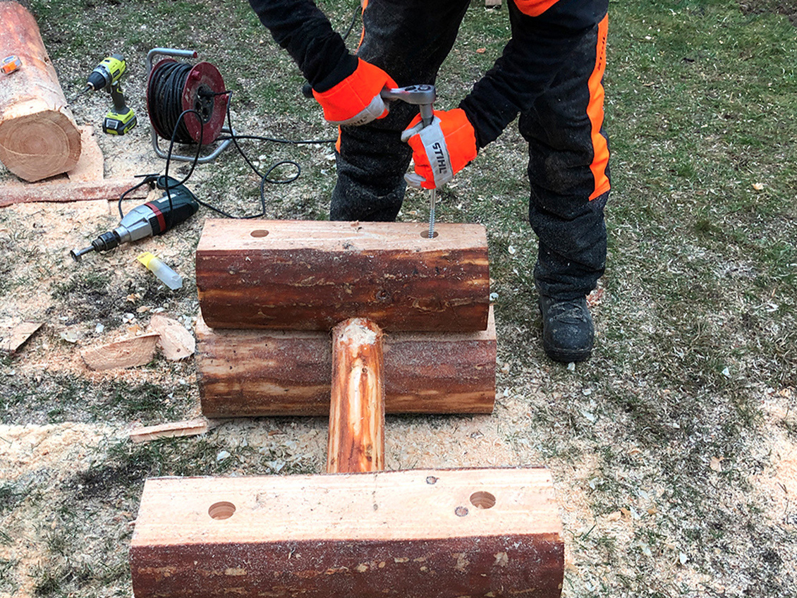 DIY garden table: legs being stacked and screwed together