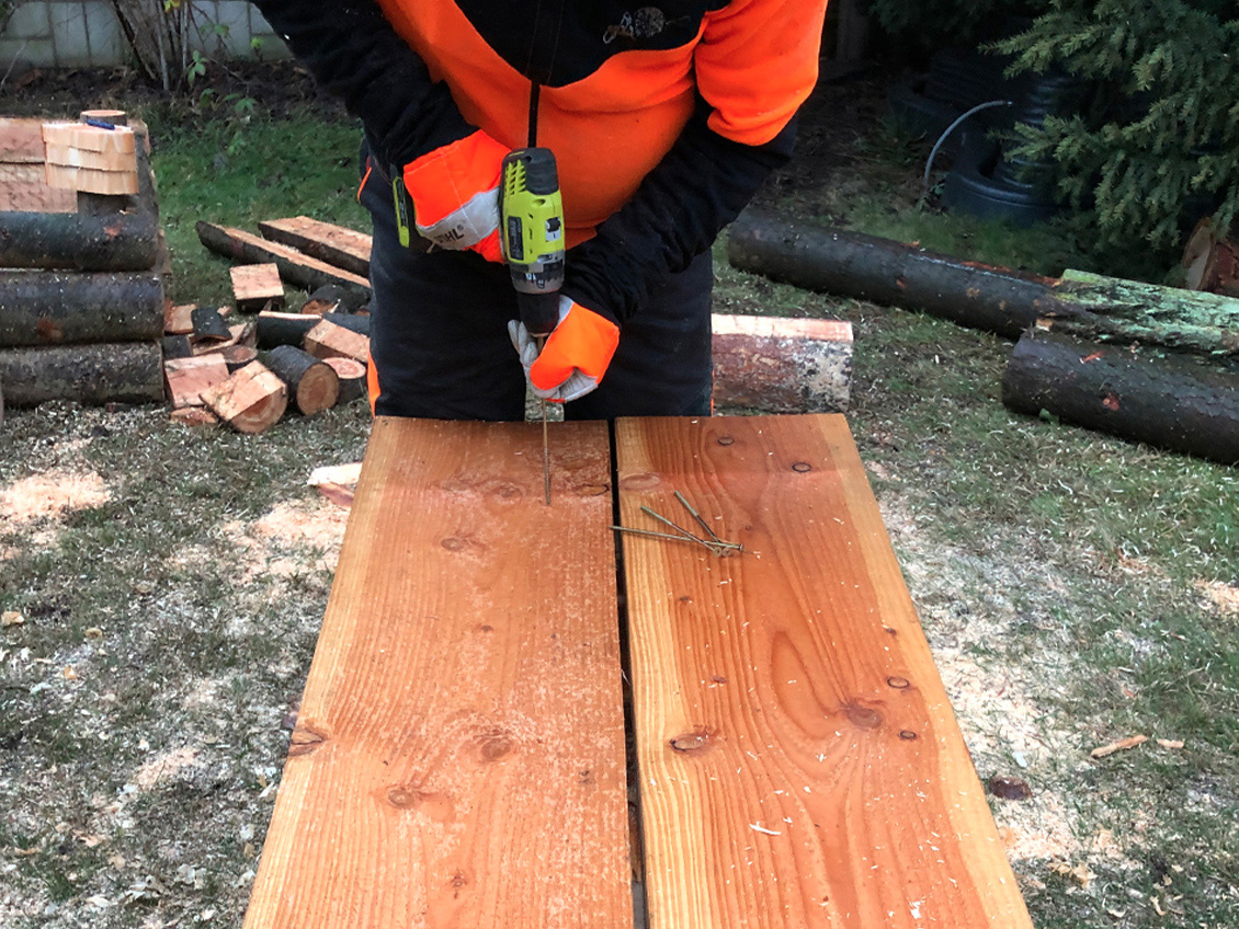 DIY garden table: tabletop being fixed to the legs