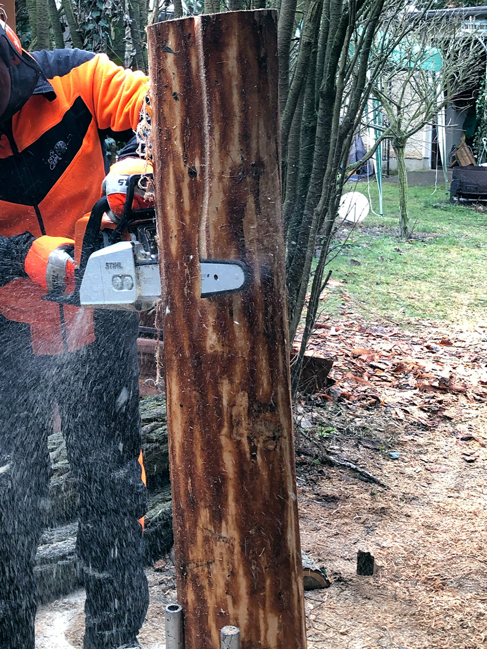 DIY garden table: a STIHL MS 170 petrol chainsaw being used to cut a long slice off