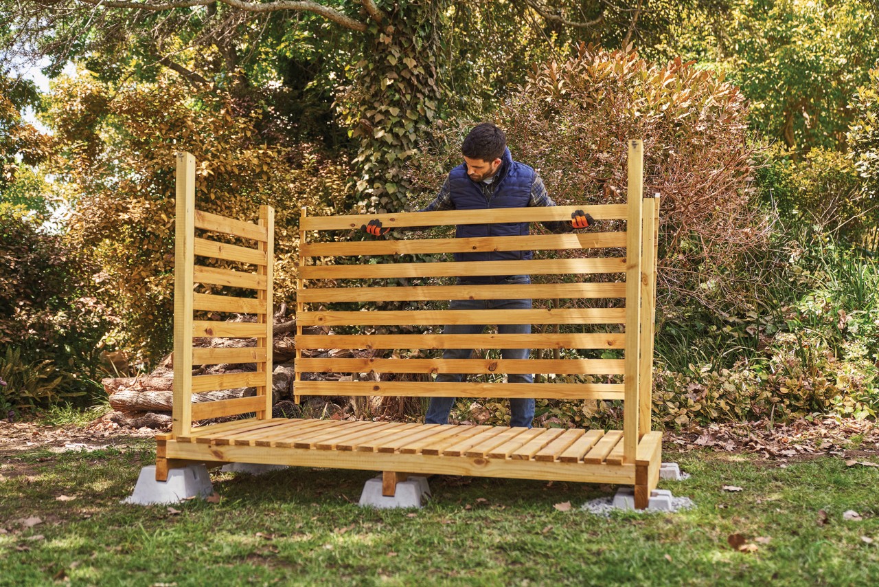 A man fitting the back wall panel 