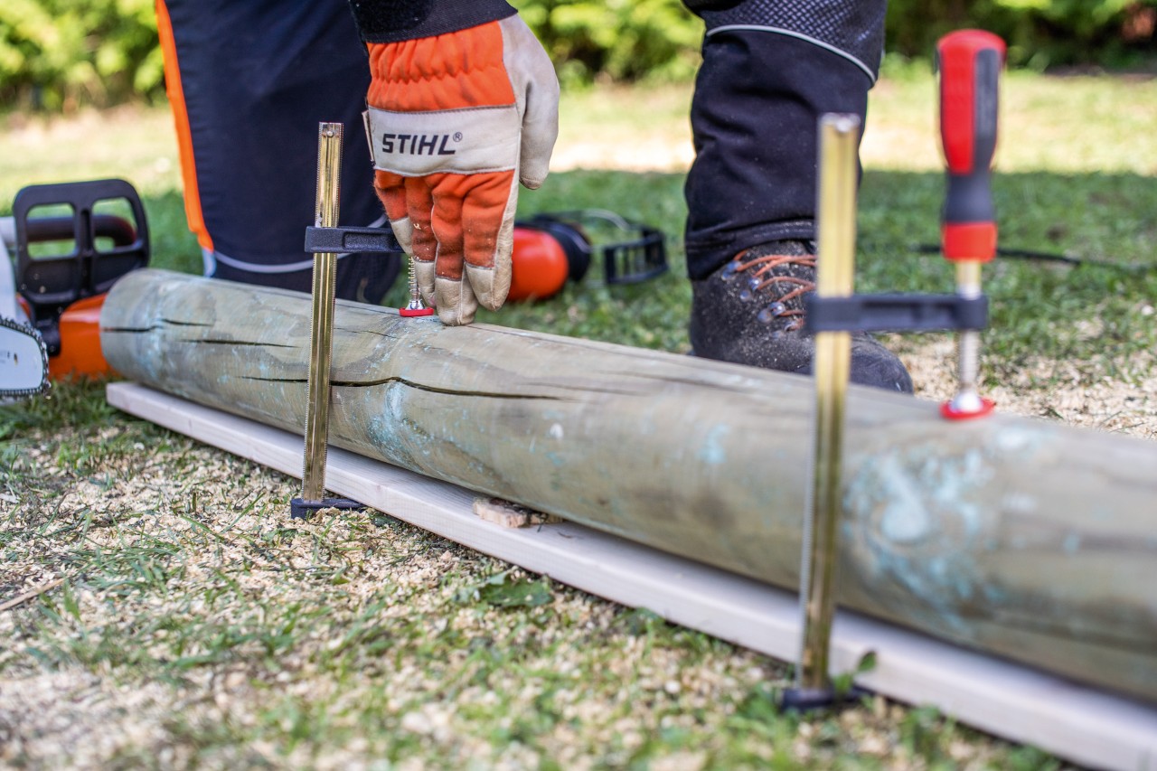 A stake is secured against rolling away using screw clamps