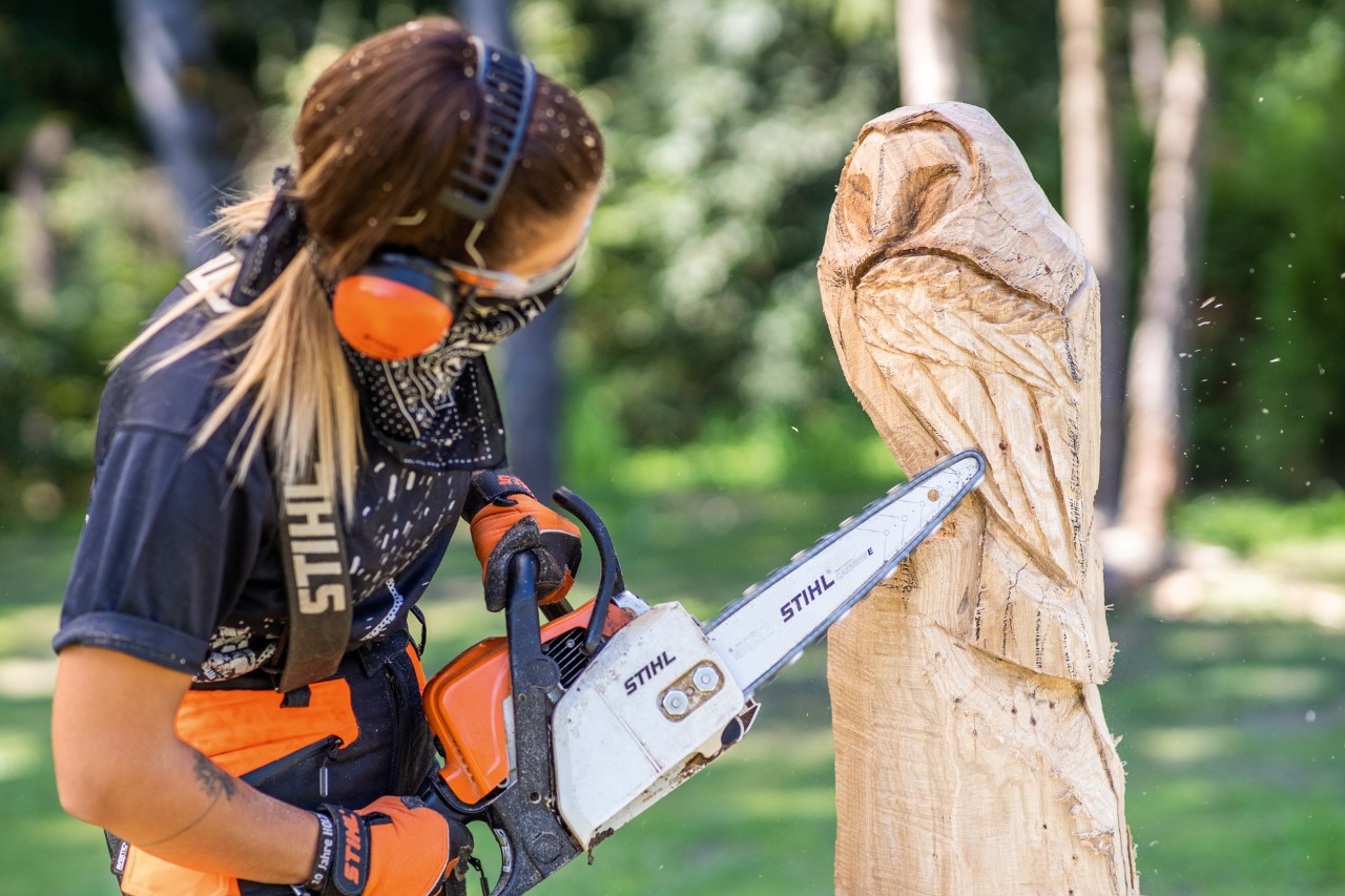 A wooden owl sculpture in progress: flight feathers are added using a STIHL chainsaw with carving set.