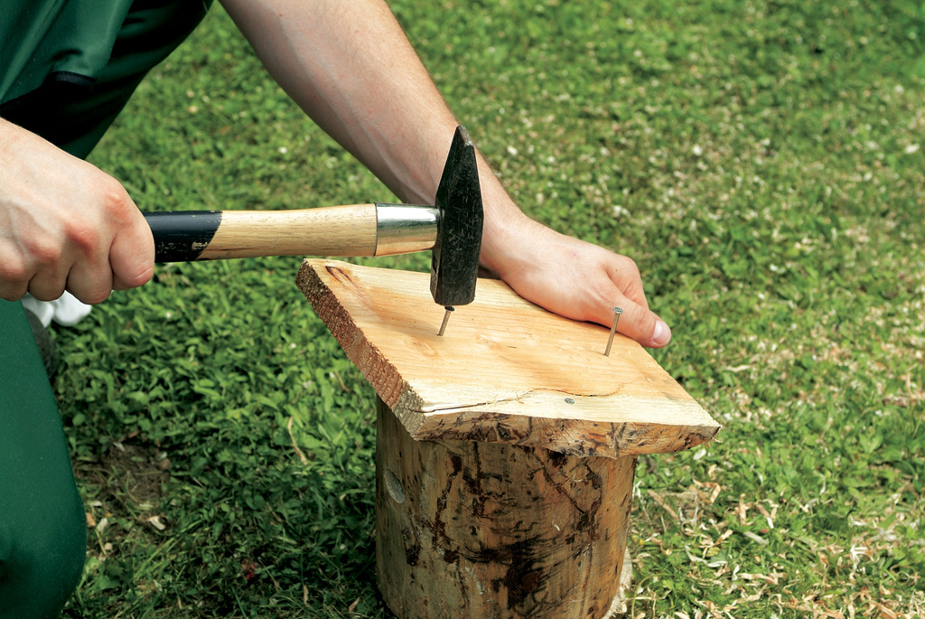 The base and roof are secured to the body using a hammer and nails
