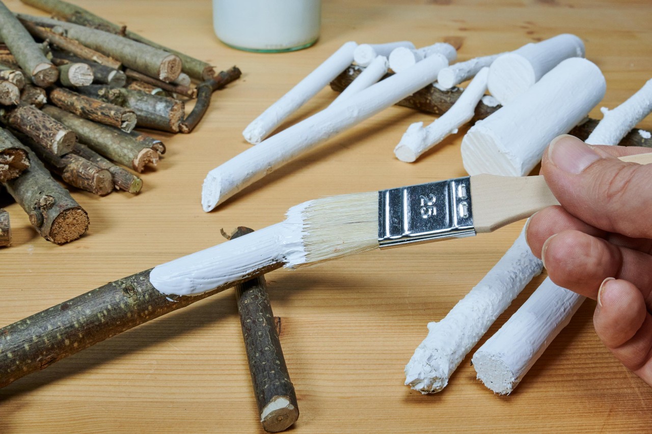 DIY advent wreath: twigs being painted white