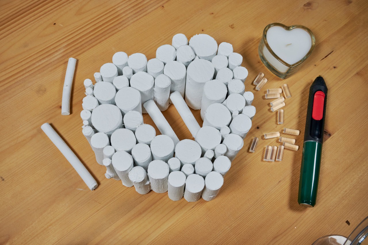 Two branches glued into center of the heart act as a platform for the candle