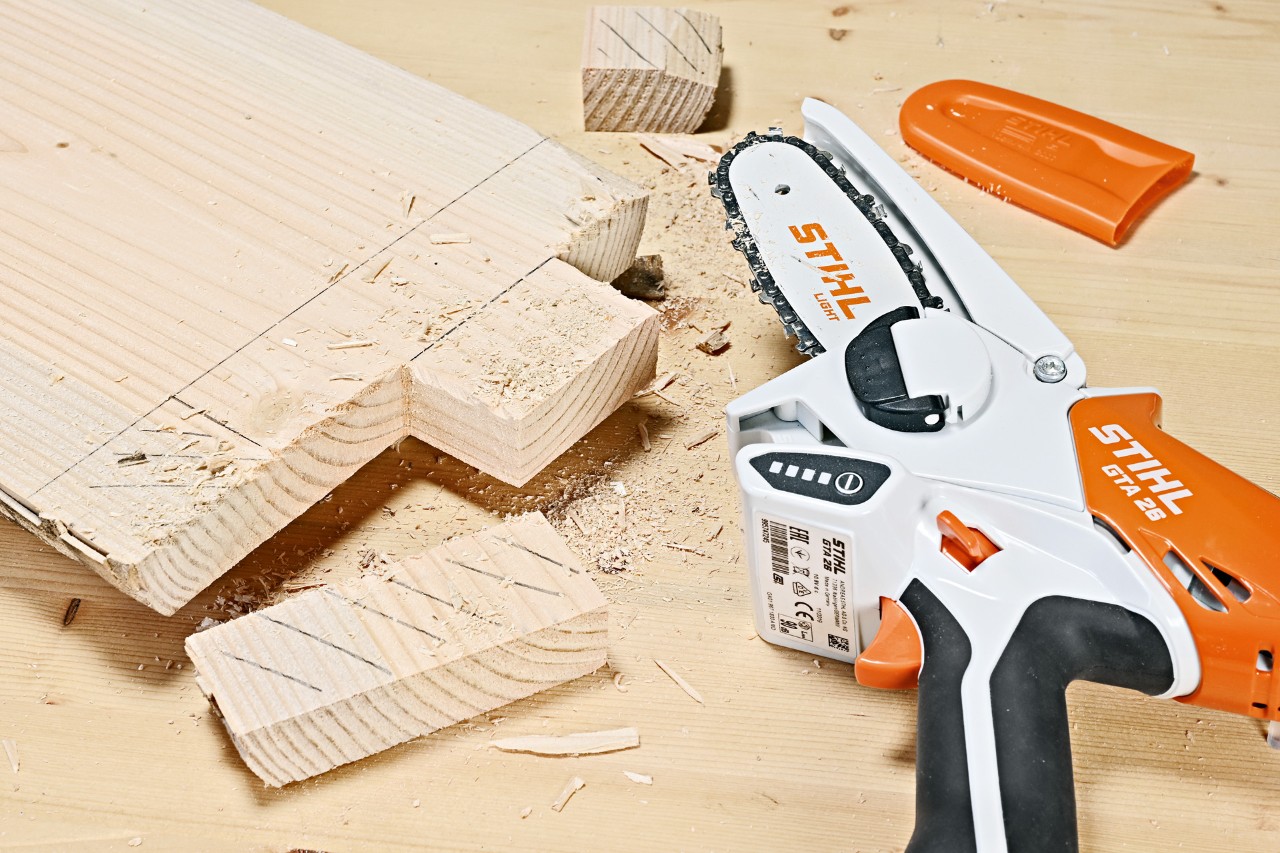 Sections being cut off a wooden plank by a STIHL GTA 26 cordless garden pruner