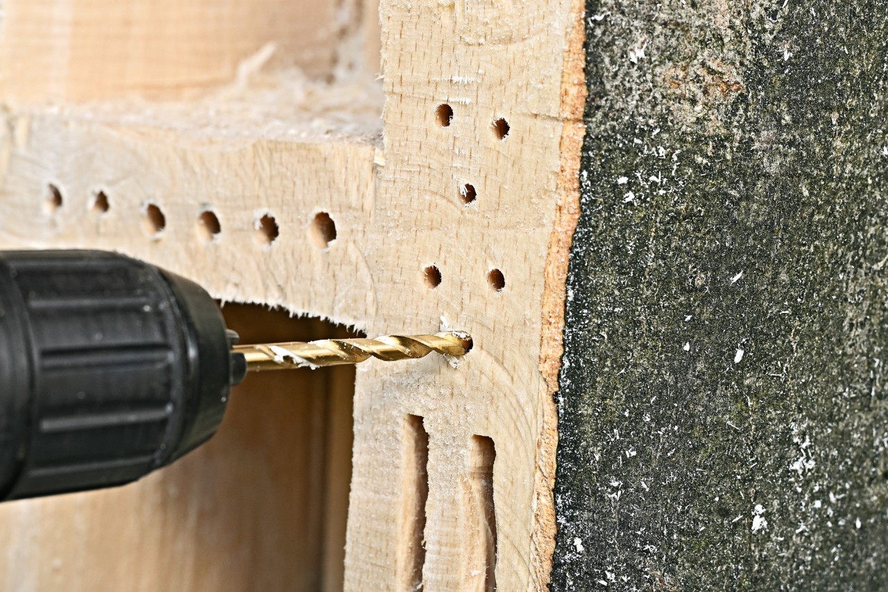 Close-up of holes being drilled into the bug hotel