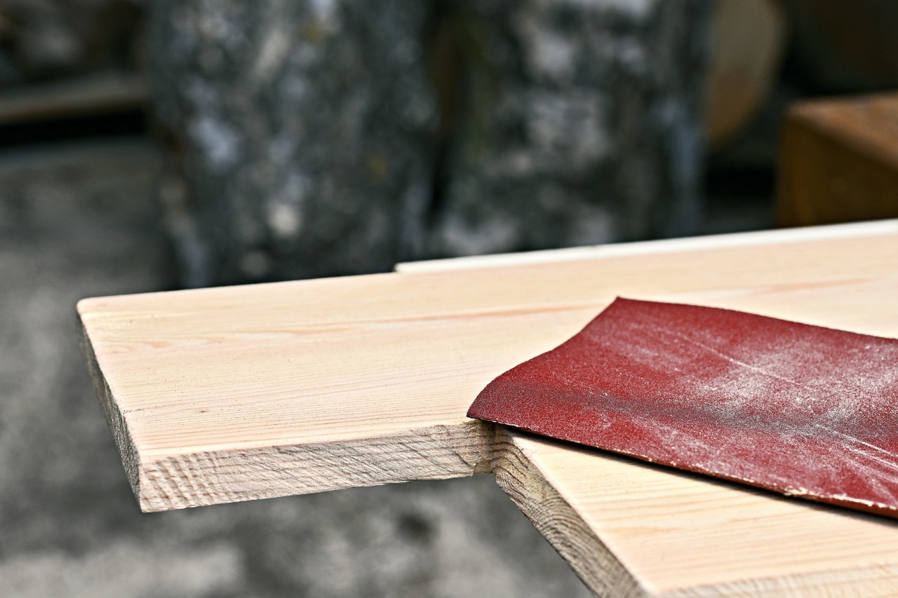 Sandpaper on a wooden board with a square cut out