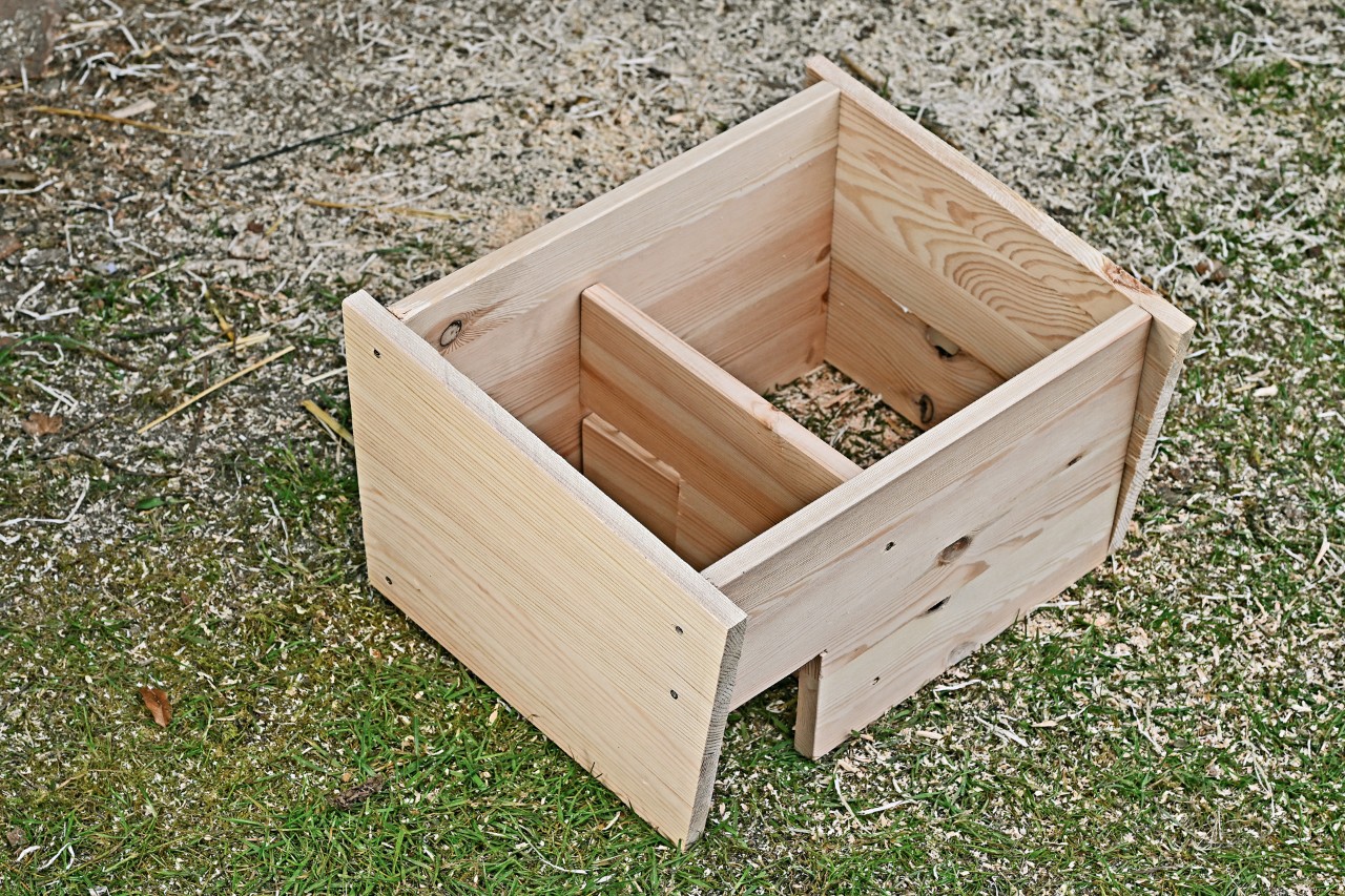 A partly assembled hedgehog house without a roof