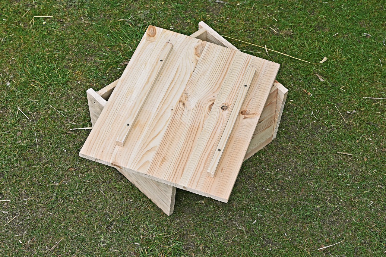 An unattached roof board with wooden battens on a DIY hedgehog house