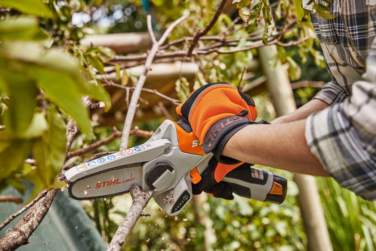 The STIHL GTA 26 cordless garden pruner being used to trim a branch