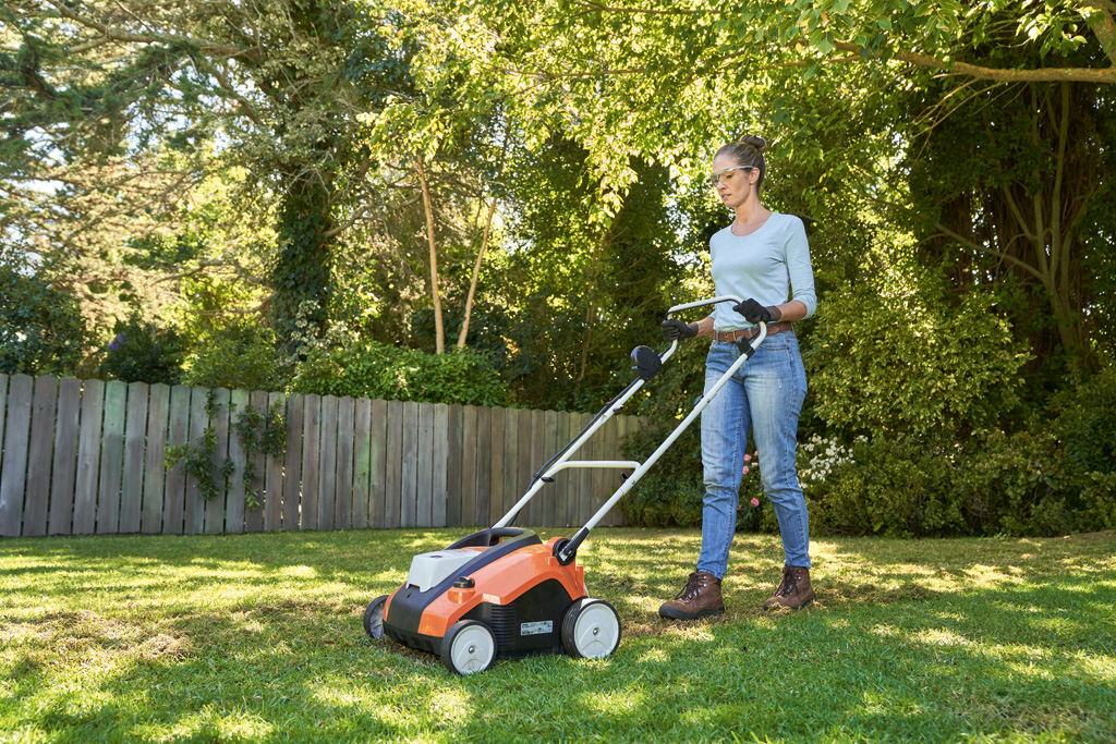 Woman scarifying a lawn using the STIHL RLA 240 cordless scarifier