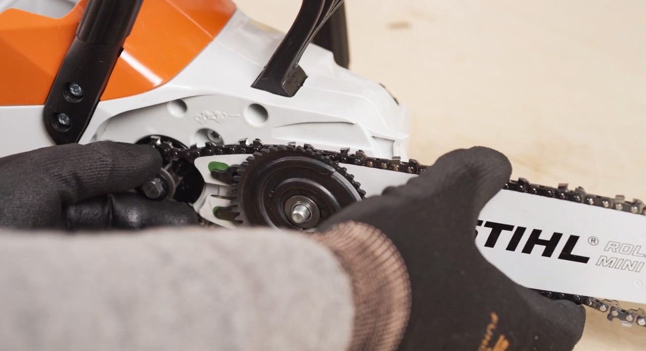 A cutting attachment being fitted on a STIHL MSA 120 cordless chainsaw