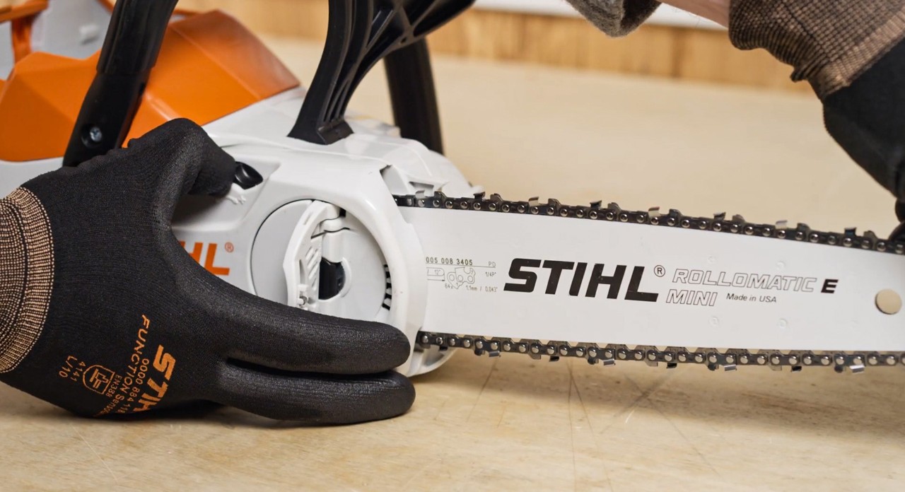 The saw chain of a STIHL MSA 120 cordless chainsaw being tightened after fitting