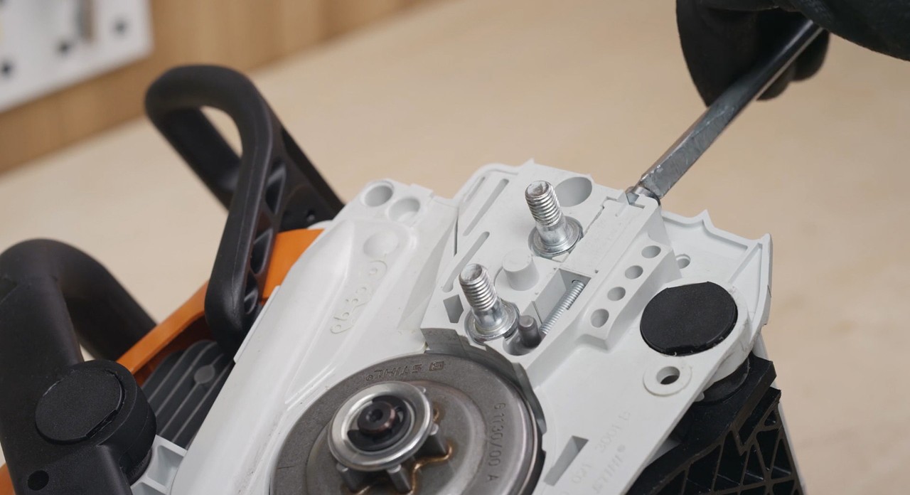 Close-up of the tensioning mechanism on a STIHL MS 170 cordless chainsaw
