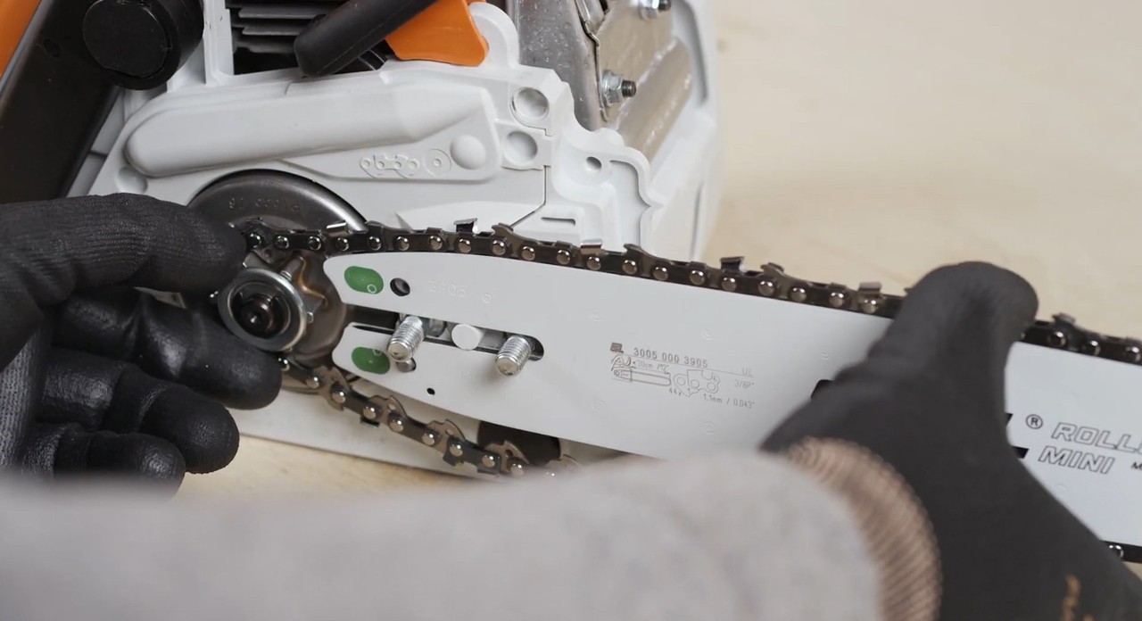 The cutting attachment being installed on a STIHL MS 170 cordless chainsaw