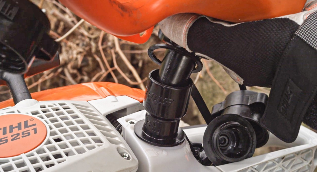 A STIHL MS 251 chainsaw being filled with fuel
