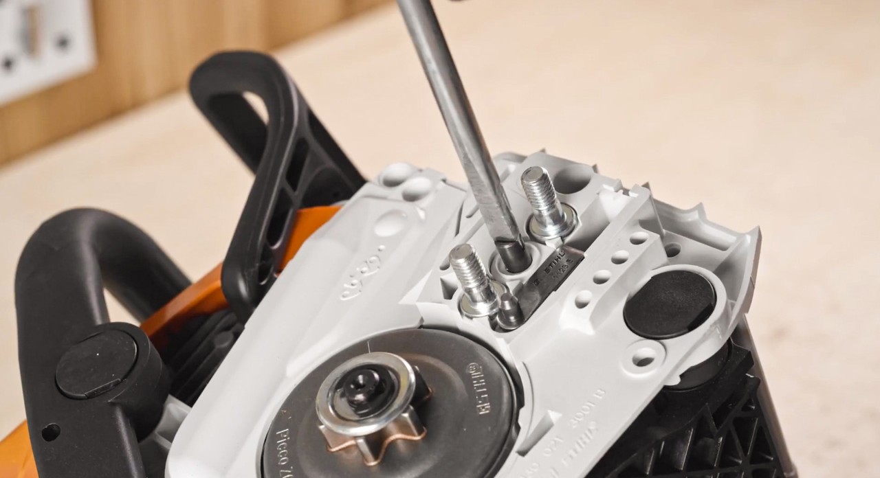 Close-up of the tensioning mechanism on a STIHL MSA 180 cordless chainsaw