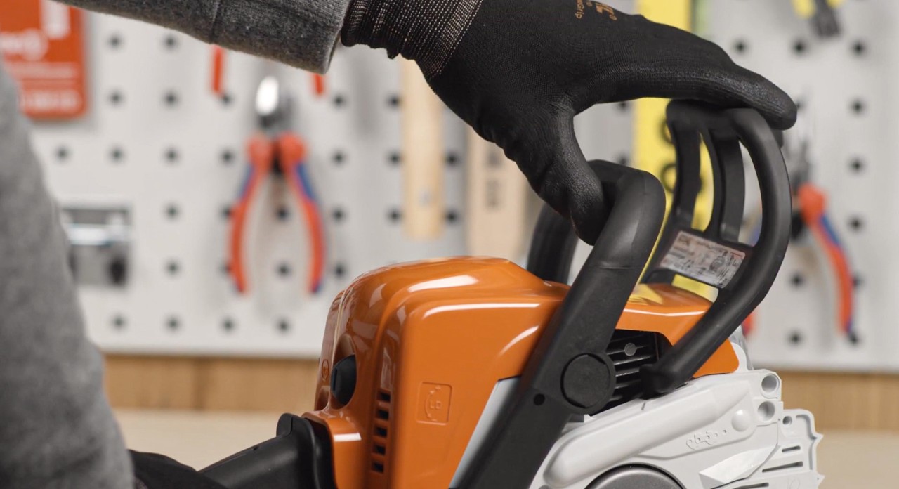 The chain brake on a STIHL MSA 180 cordless chainsaw being released