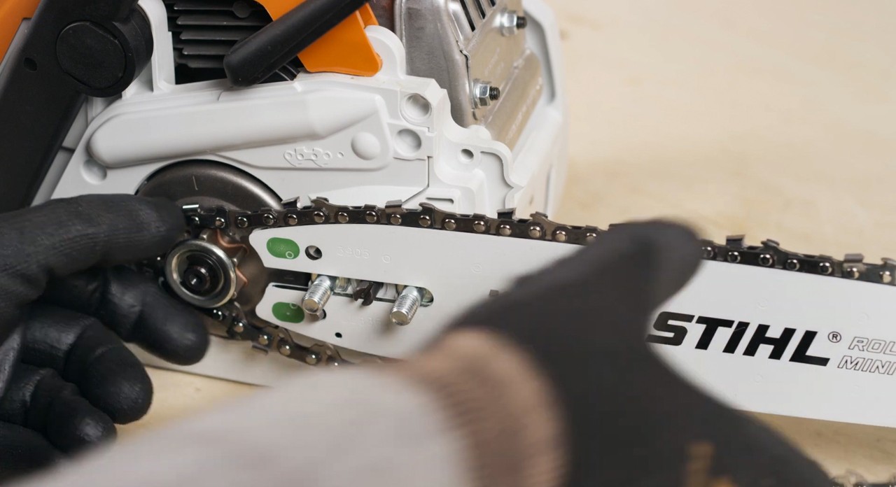 The cutting attachment being installed on a STIHL MSA 180 cordless chainsaw