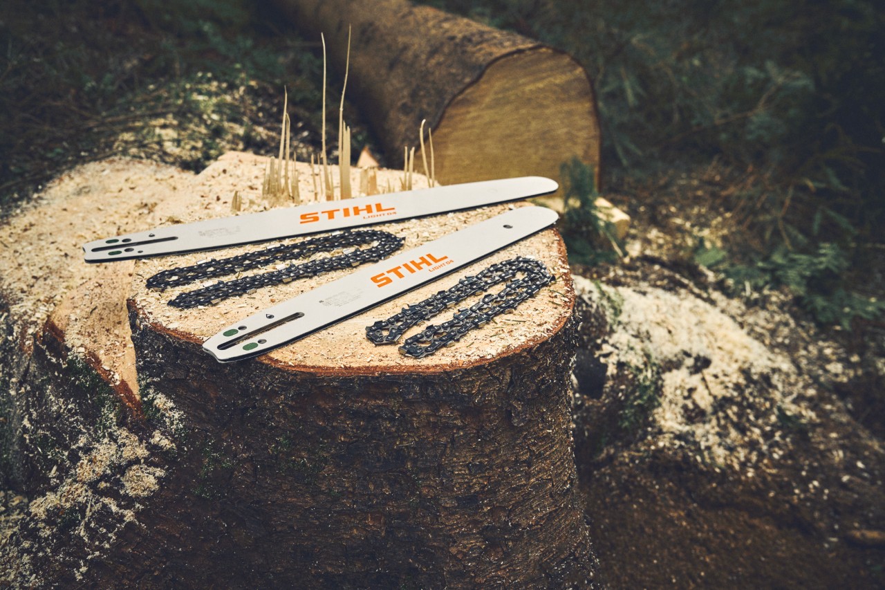 stihl guide bar and chainsaw chain on log