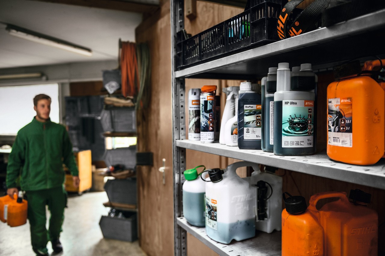 man walking towards shelf of STIHL oils and fuels
