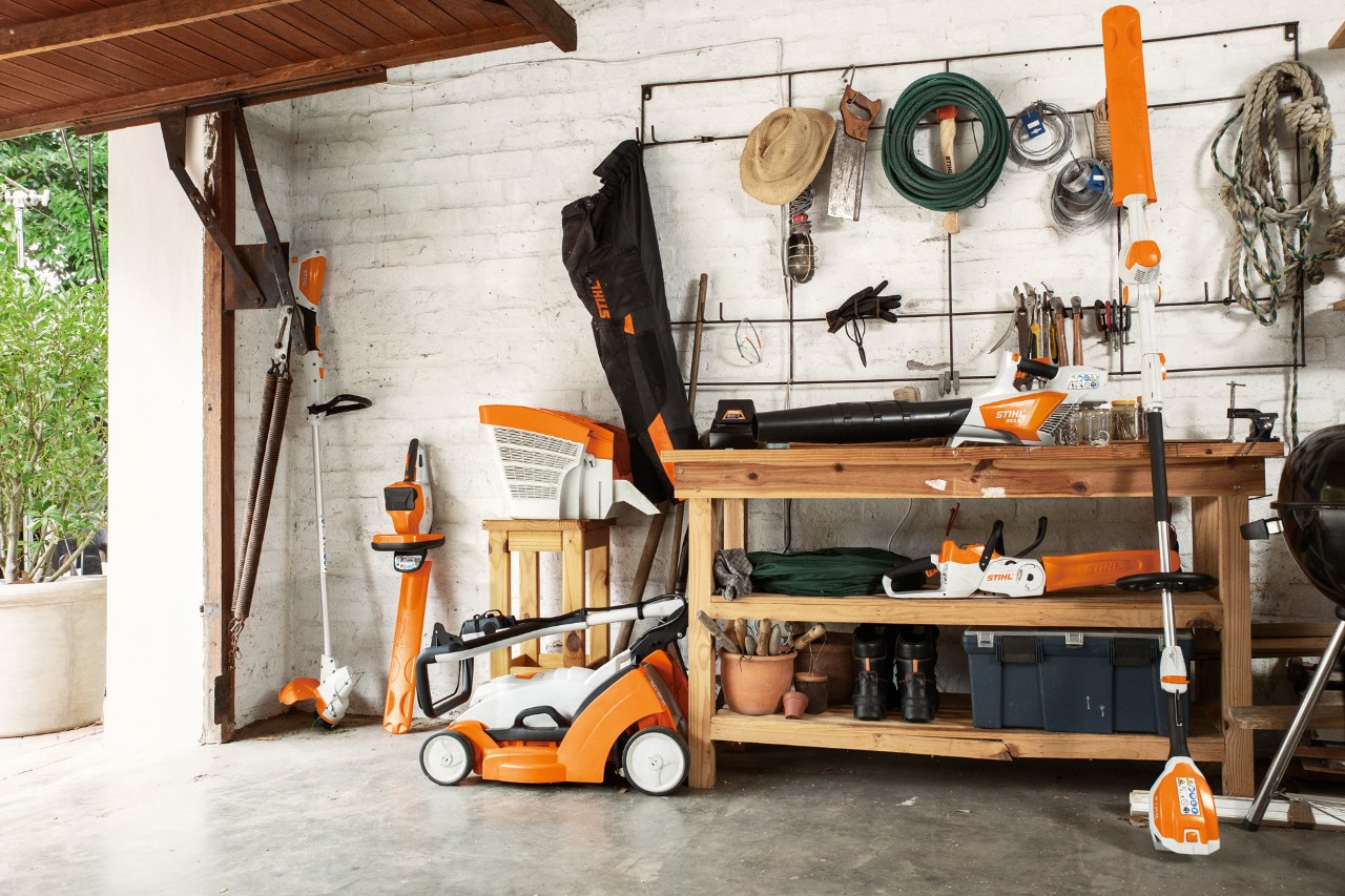 A garage interior with a wide range of STIHL products, including the FSA 56 cordless grass trimmer.
