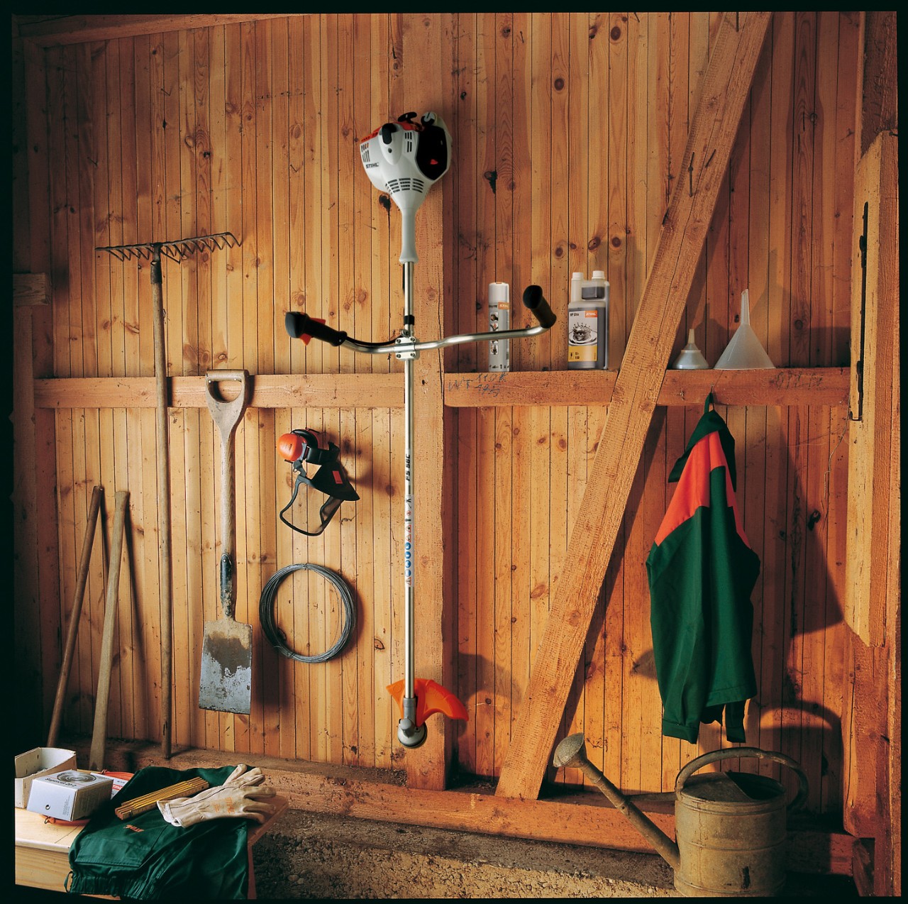 The FS 56 cordless brushcutter stored hanging up in a tool shed