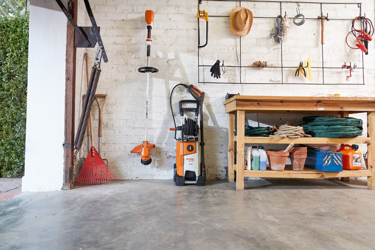 STIHL RE 130 PLUS high-pressure cleaner in a garage with other tools