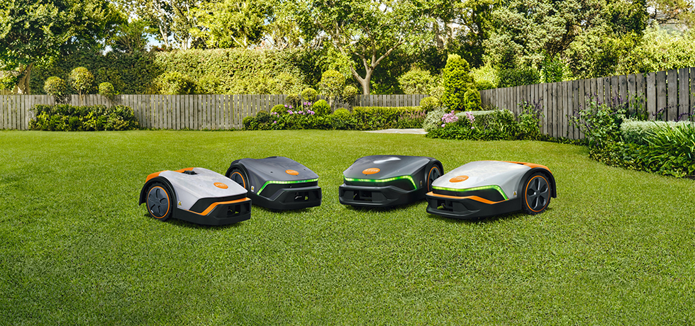 A STIHL iMOW® robot lawn mowers sitting on a green, lush lawn