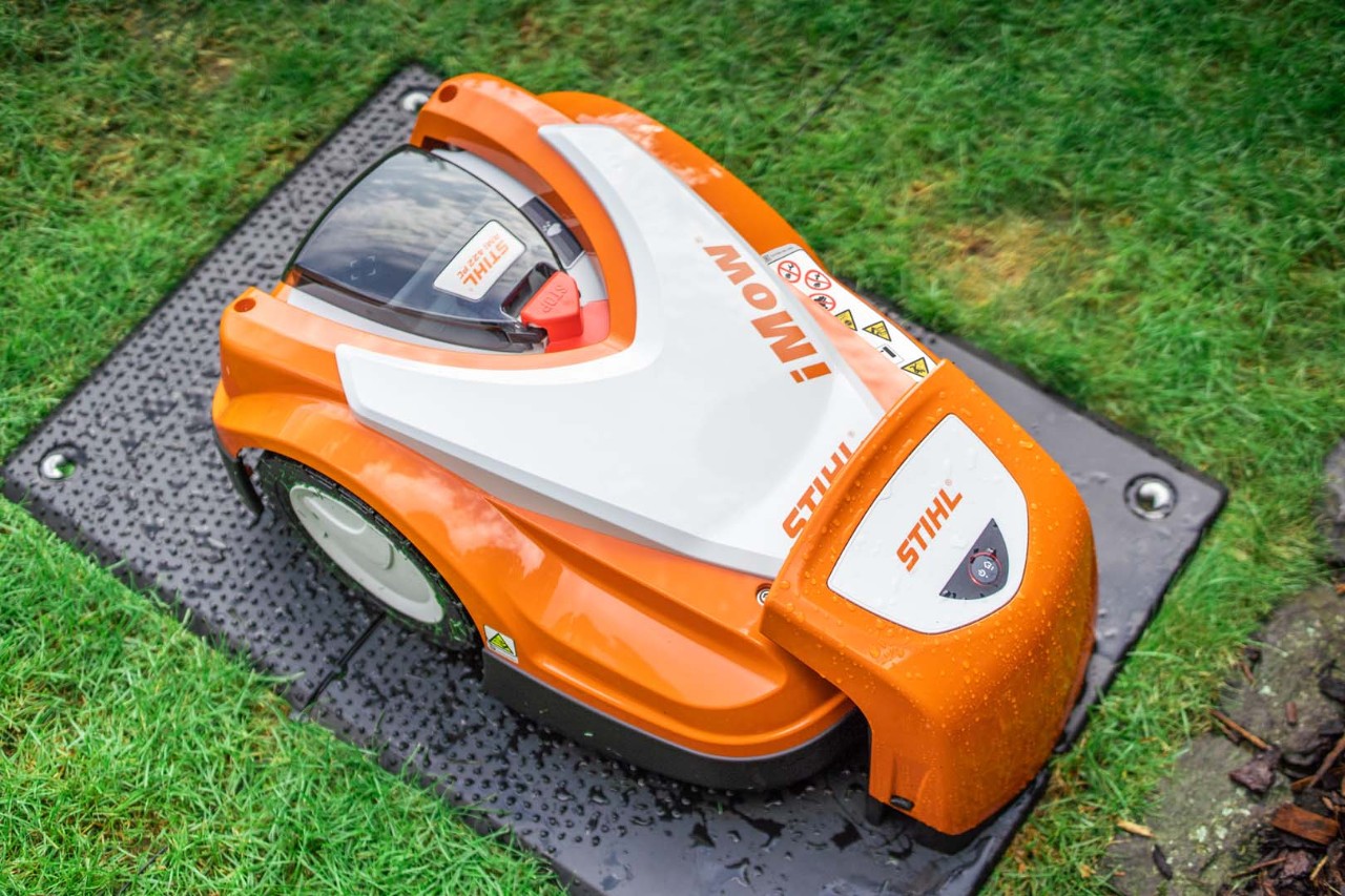 A STIHL iMOW® 422 robot lawn mower in its docking station