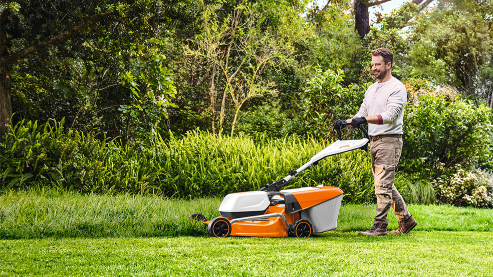 Man mowing lawn with RMA 235 T