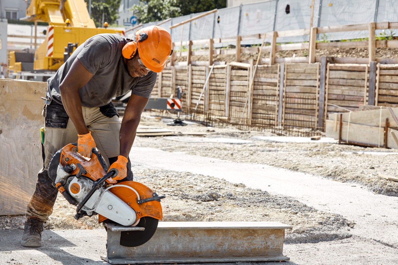 A steel girder being cut with a STIHL MS 500i cut-off machine on a construction site