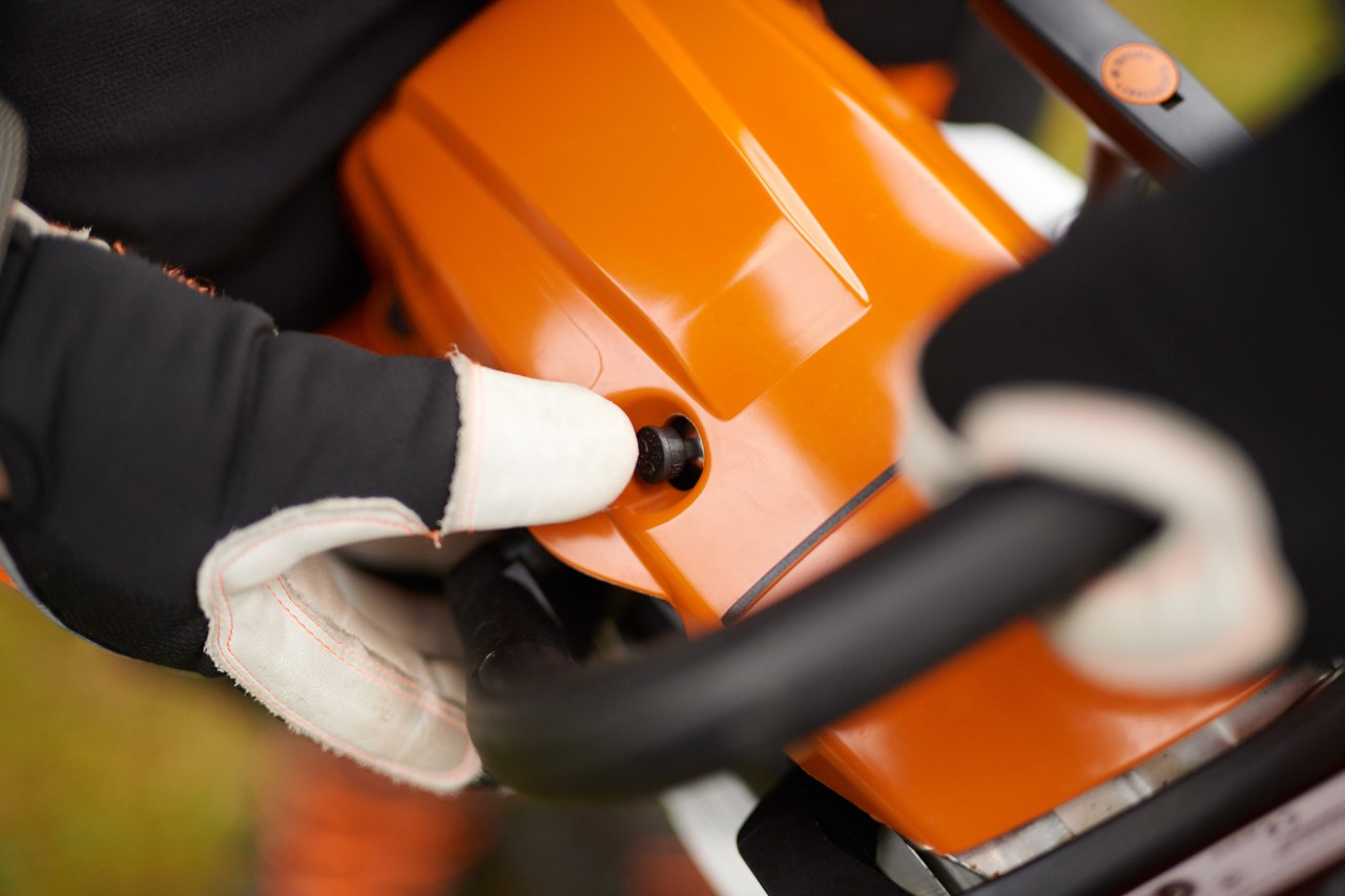 A man wearing protective equipment working with a STIHL TS 500i cut-off machine on a construction site