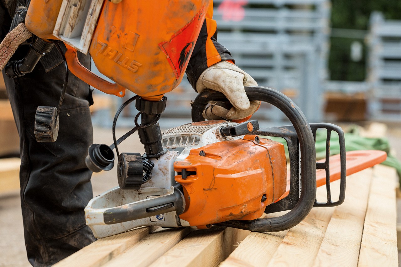 A STIHL MS 261 petrol chainsaw being filled with fuel