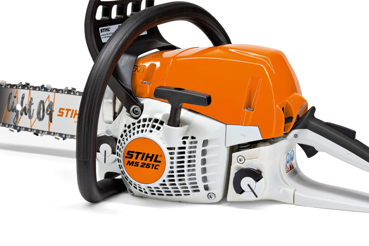A STIHL MS 180 C-BE petrol chainsaw with ErgoStart on grass, being started up