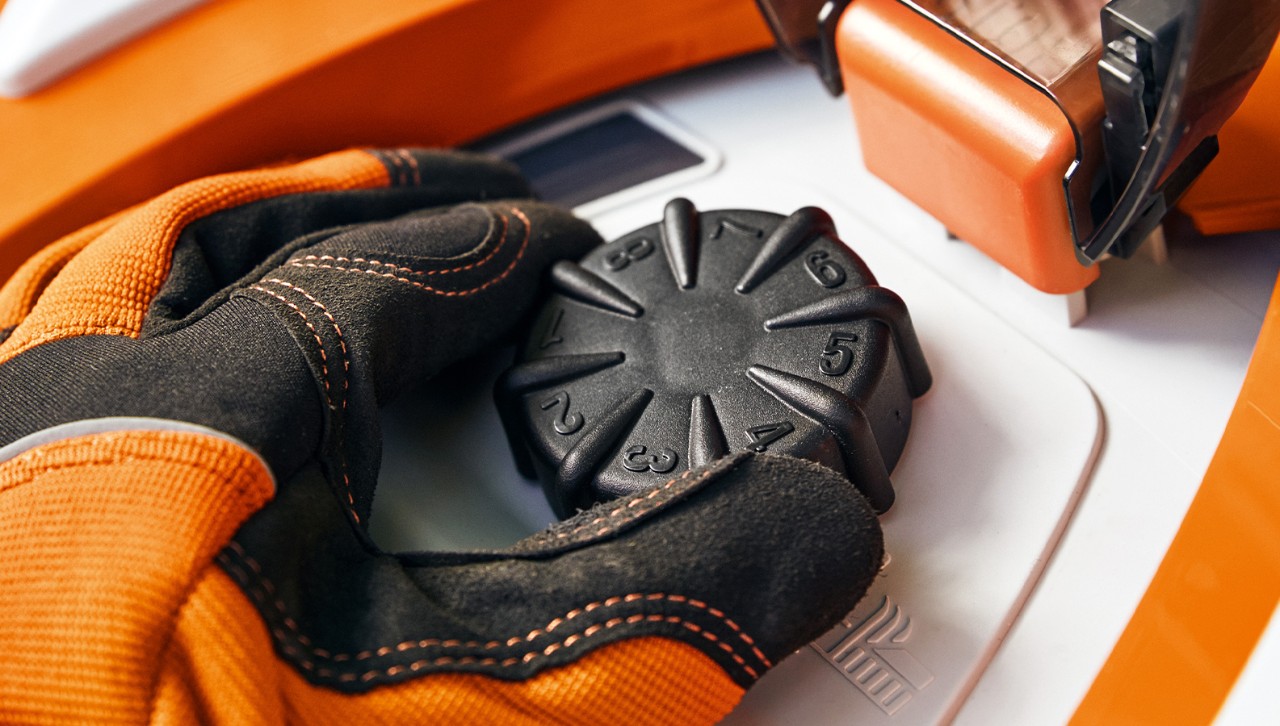 Close-up of the cut height adjustment feature on the STIHL iMOW® RMI 422 robot mower