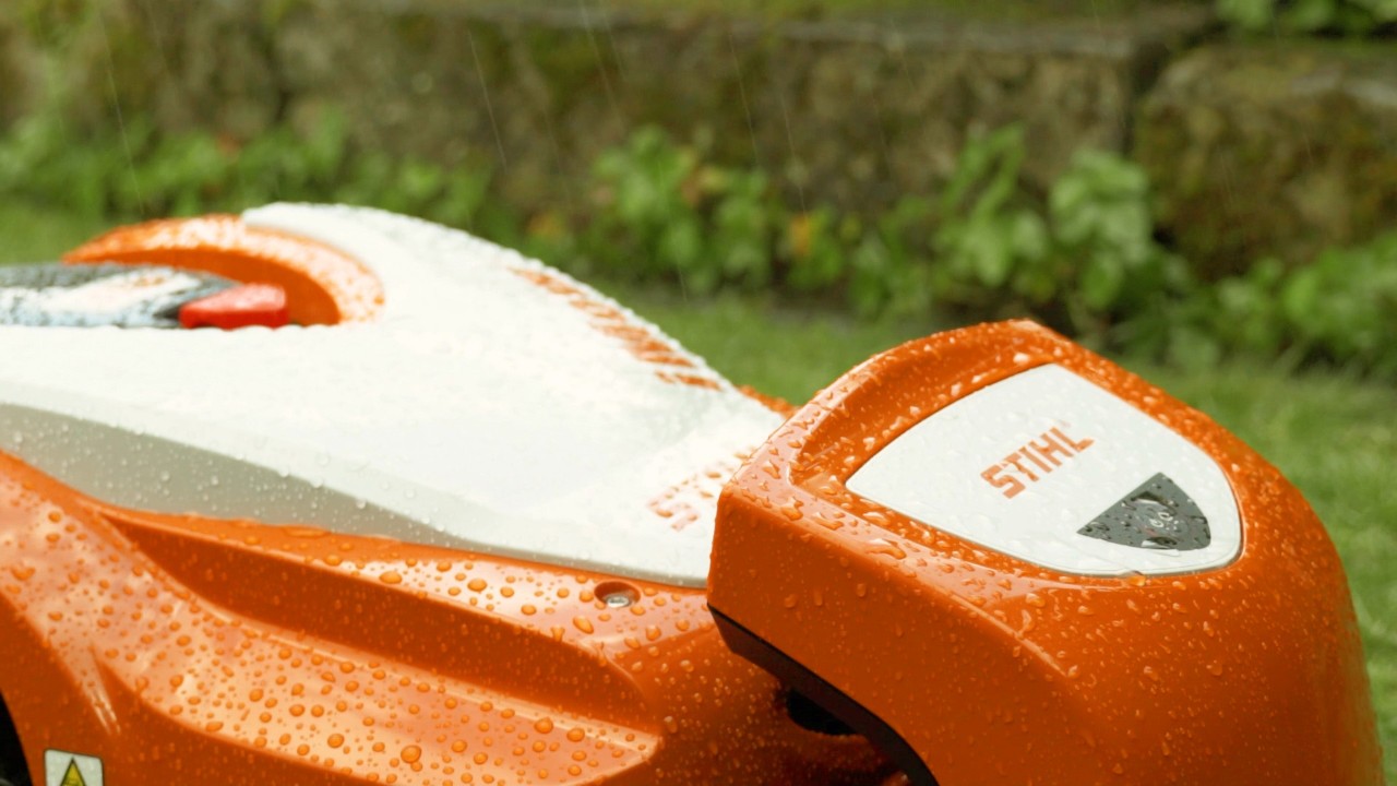 A STIHL iMOW® robot mower outside in the rain