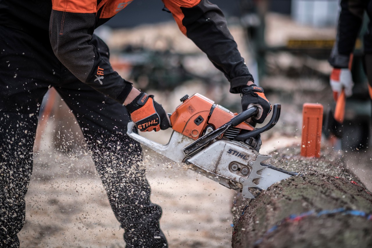 A man saws a log at a TIMBERSPORTS® Event
